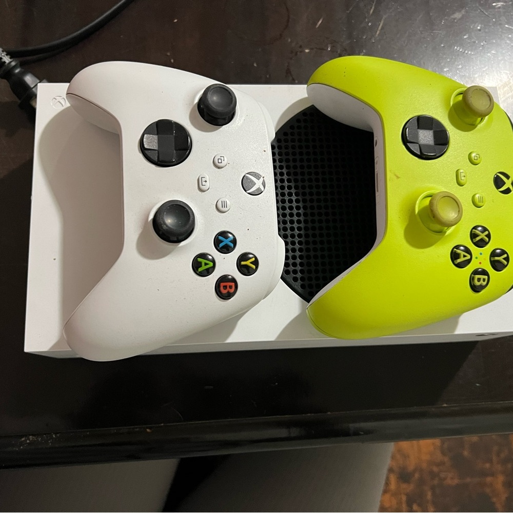 Xbox with a wireless controller and the controller so two controllers